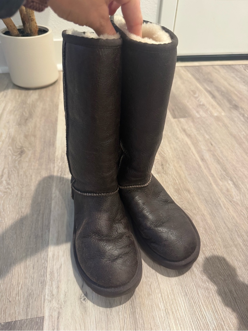 UGG Classic Tall Bomber boots w/ distressed leather exterior & sheepskin lining